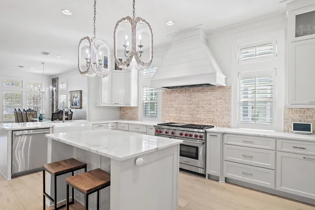 an open kitchen with a table and chairs in it
