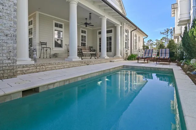 a swimming pool view with a outdoor seating