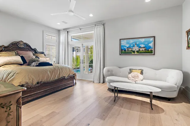 a bedroom with furniture and a large window