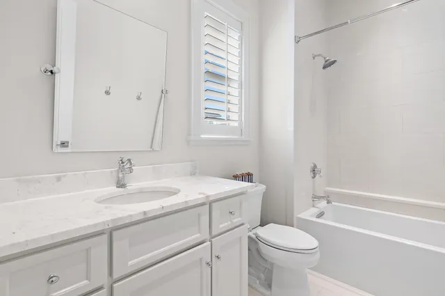 a bathroom with a sink toilet vanity and bathtub