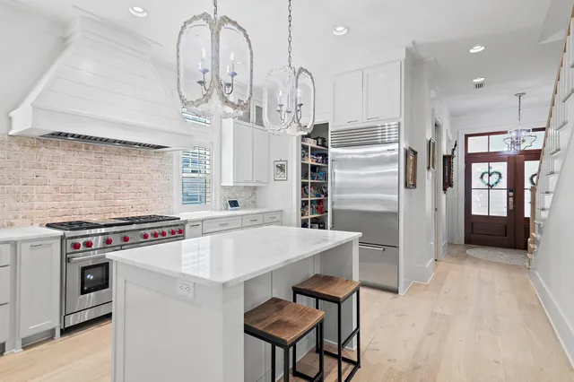 a kitchen with stainless steel appliances a stove a refrigerator and cabinets