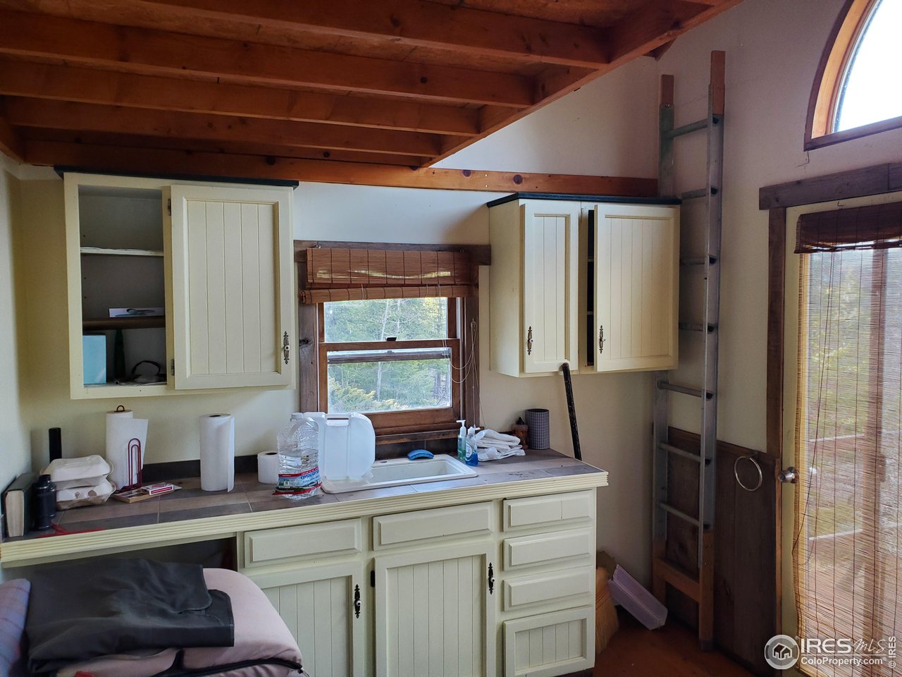 1375 Crow Road Red Feather Lakes, CO 80545 - Photo 17 of 17 a kitchen with a sink cabinets and window