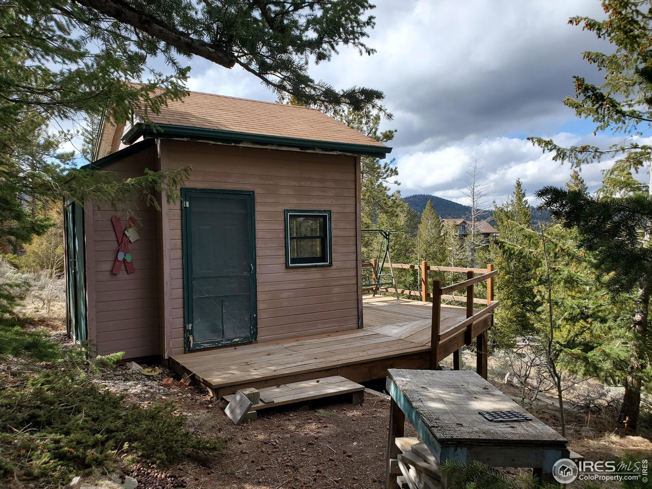 1375 Crow Road Red Feather Lakes, CO 80545 - Photo 6 of 17 a view of a chairs and table in backyard of the house