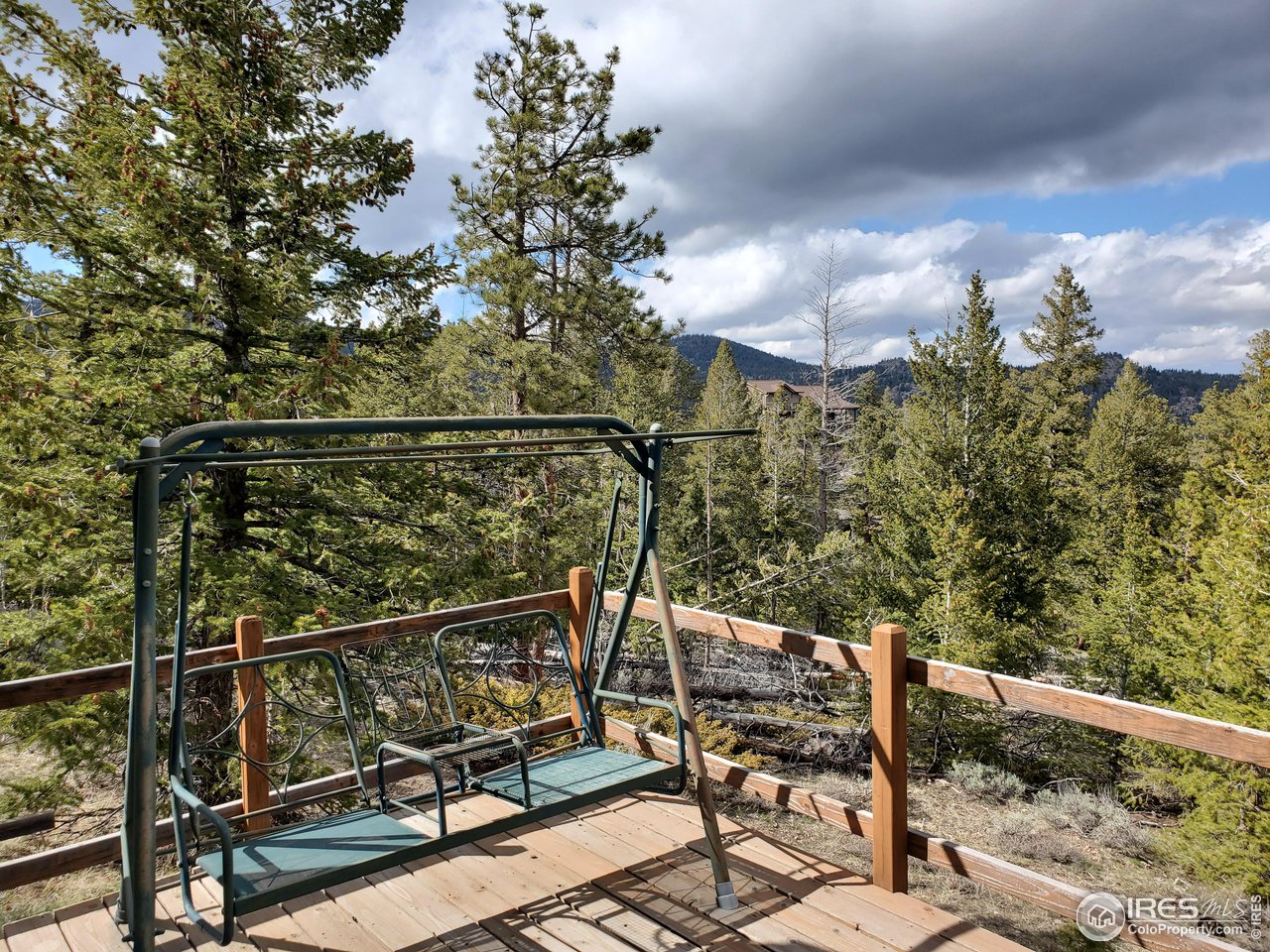 1375 Crow Road Red Feather Lakes, CO 80545 - Photo 7 of 17 a view of balcony with wooden floor and outdoor seating