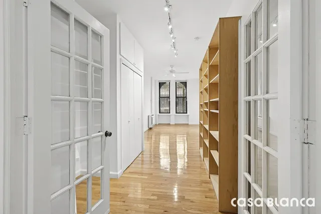 a bedroom with a bed and a painting on the wall
