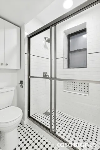a view of a hallway with wooden floor and dining room