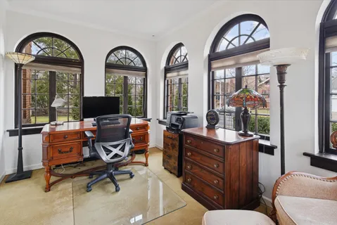 a bedroom with a bed window and a chandelier