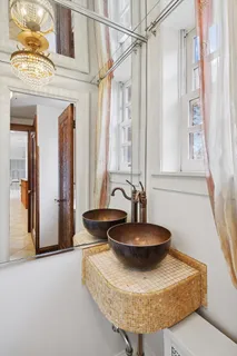 a bedroom with a bed and a chandelier