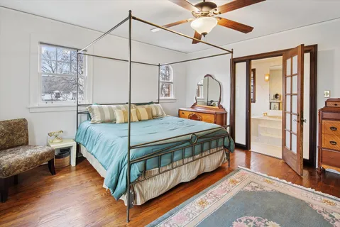 a spacious bathroom with a tub sink shower and mirror