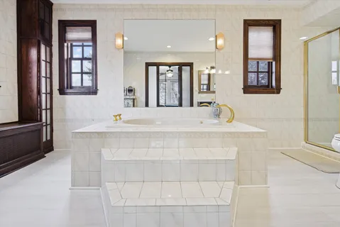 a bedroom with a bed wooden floor and window