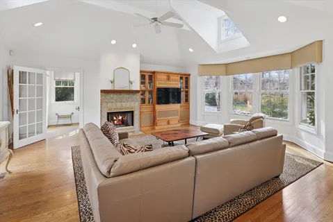 a living room with furniture a flat screen tv and a fireplace