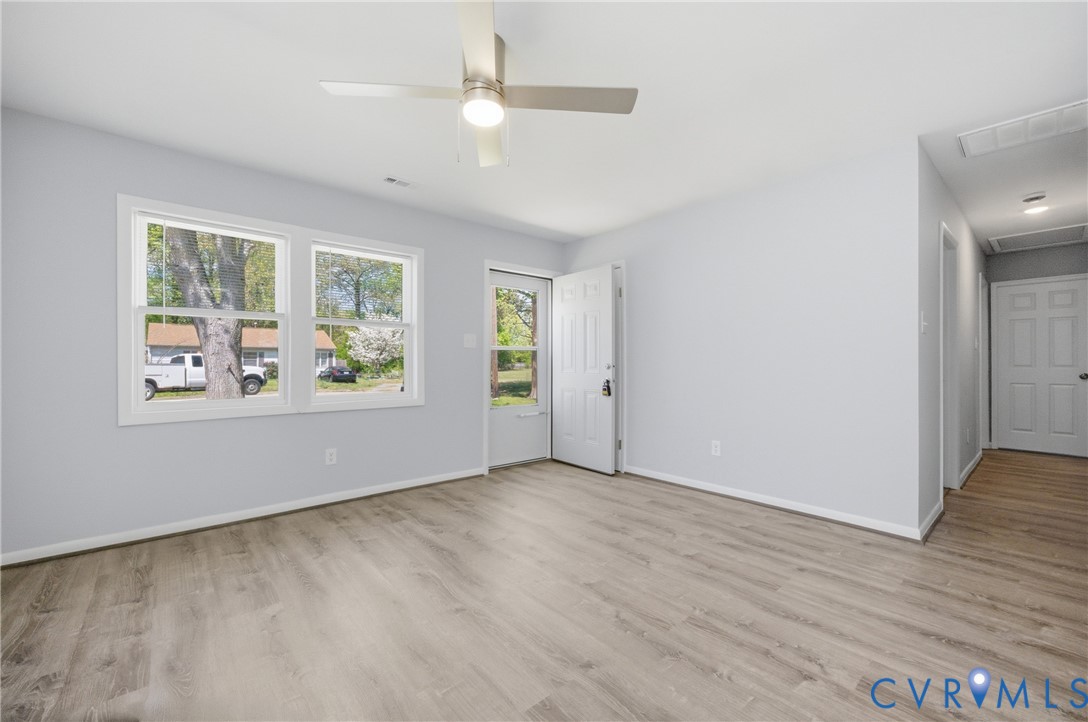 1914 Moger Drive Hampton, VA 23663 - Photo 4 of 15 an empty room with wooden floor chandelier fan and windows