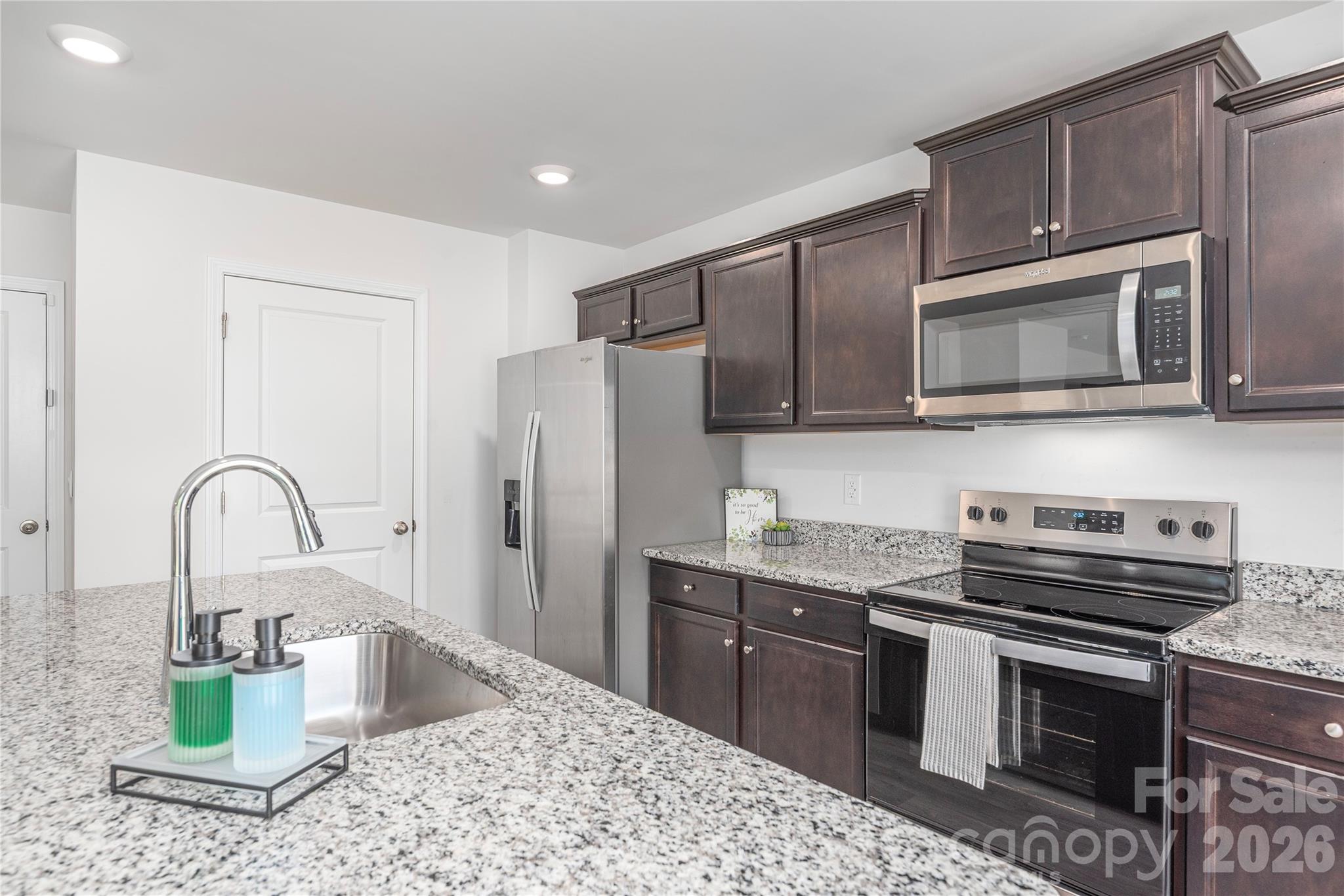 8 Madelyn Drive Clyde, NC 28721 - Photo 16 of 43 a kitchen with stainless steel appliances granite countertop a stove refrigerator sink and microwave