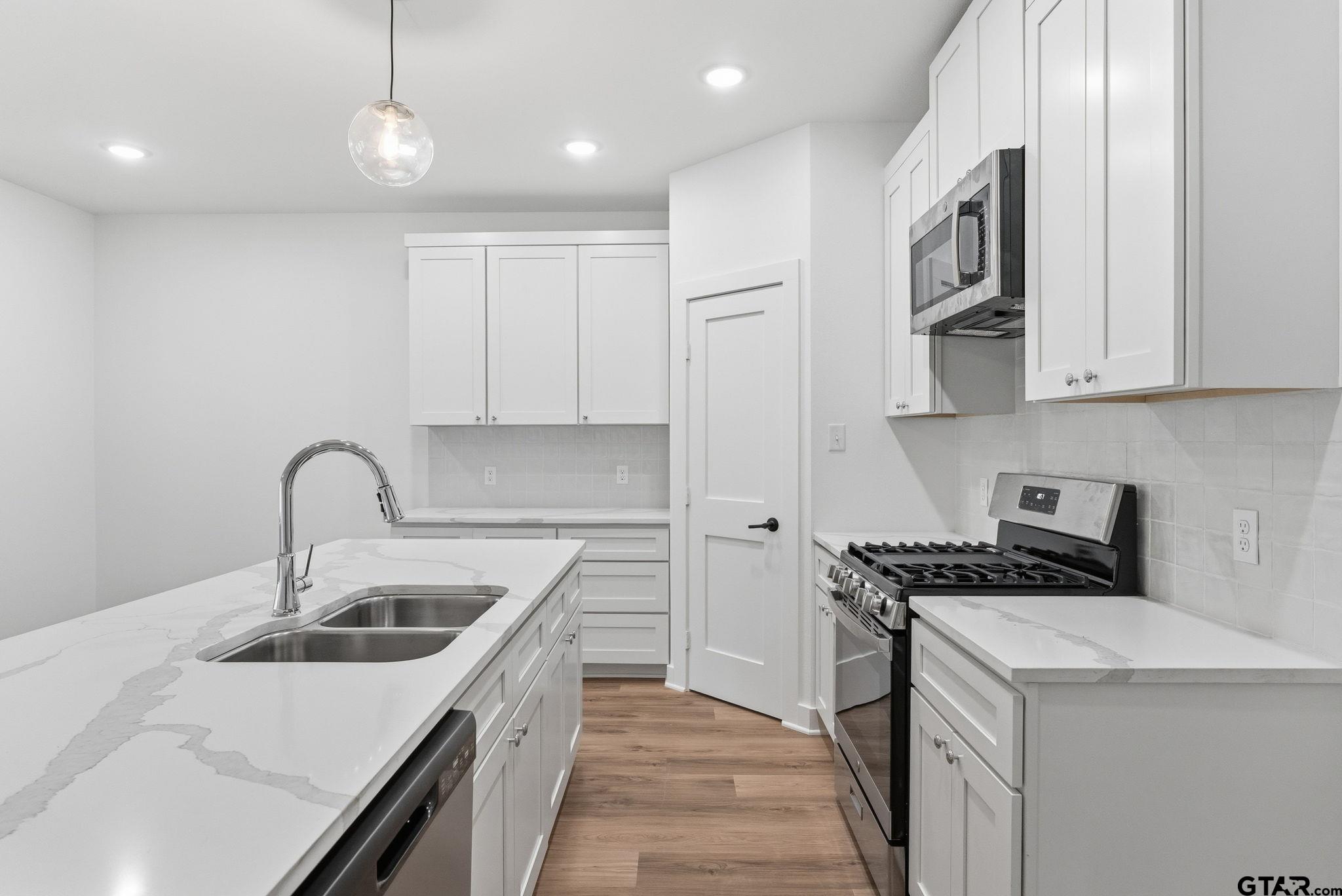 2968 Calloway Road Tyler, TX 75701 - Photo 8 of 24 a kitchen that has a sink and a stove