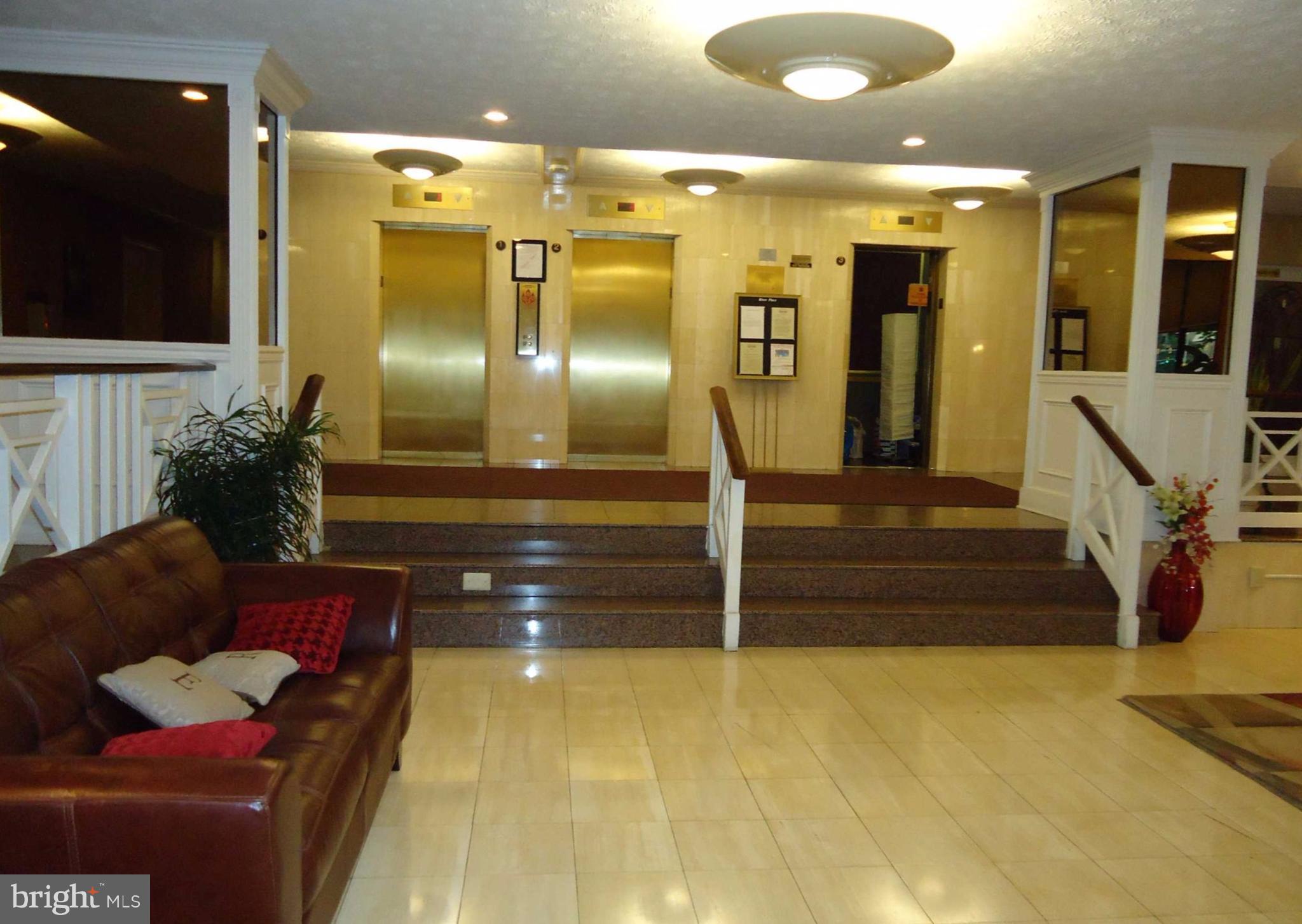1021 Arlington Boulevard, Unit 706 Arlington, VA 22209 - Photo 15 of 24 a lobby with furniture and a potted plant