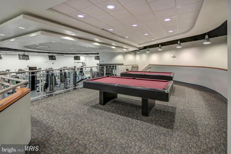 1021 Arlington Boulevard, Unit 706 Arlington, VA 22209 - Photo 20 of 24 a room with gym equipment and a table