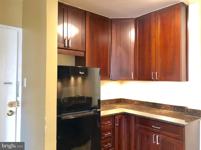 a kitchen with a refrigerator and cabinets
