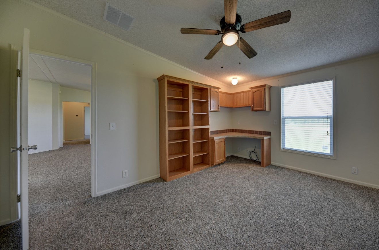 10901 Harmon School Road Burton, TX 77835 - Photo 12 of 23 a view of a livingroom with furniture and a ceiling fan