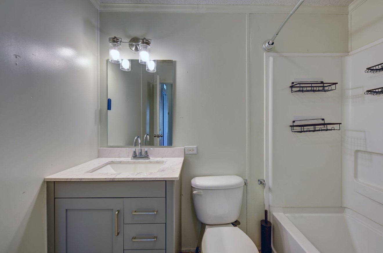 10901 Harmon School Road Burton, TX 77835 - Photo 14 of 23 a bathroom with a toilet sink and mirror