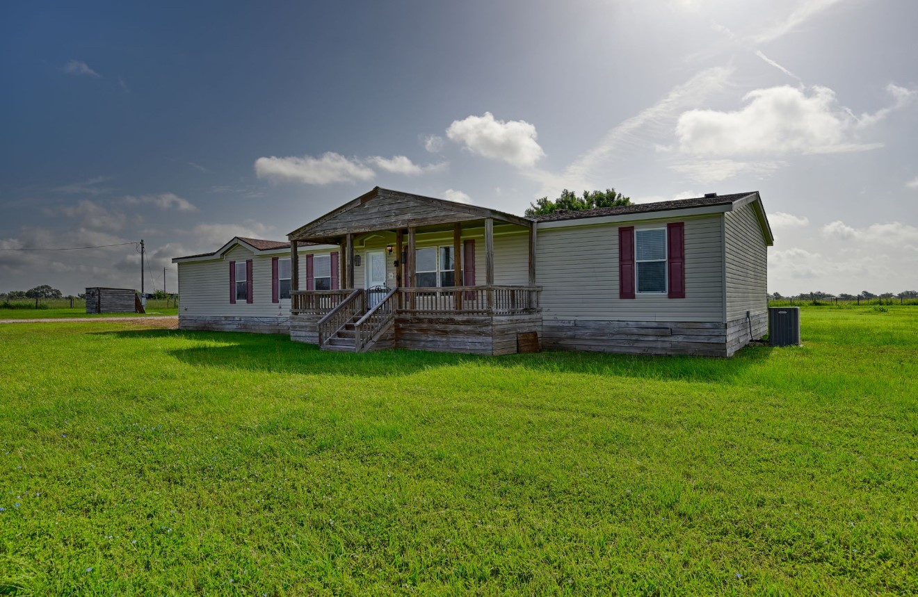10901 Harmon School Road Burton, TX 77835 - Photo 2 of 23 a front view of a house with garden