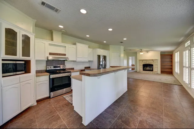 a view of a livingroom with a fireplace and a window