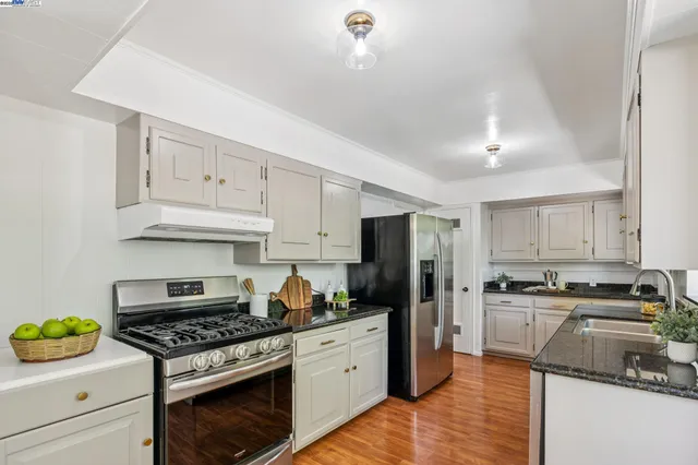 a kitchen with a stove a sink and a refrigerator