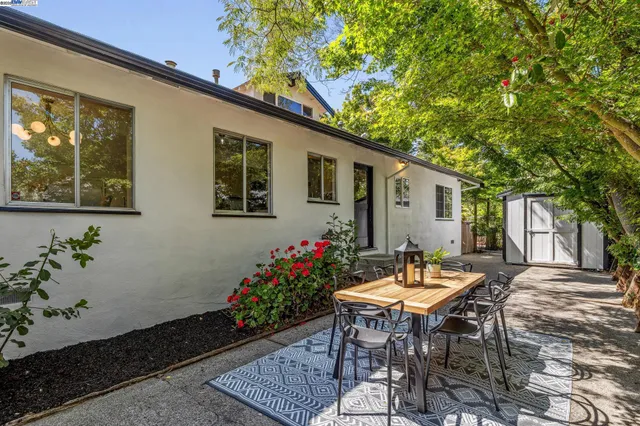 a view of a patio with a table and chairs