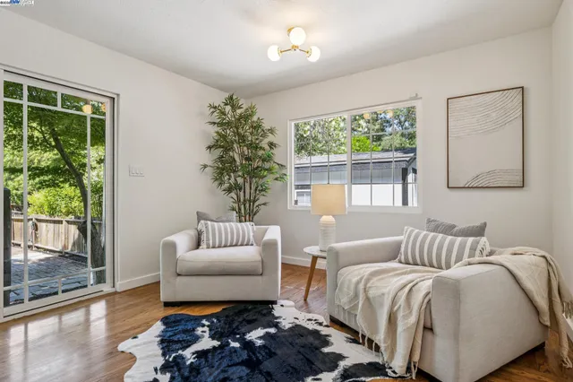 a bedroom with a bed and a couch with window