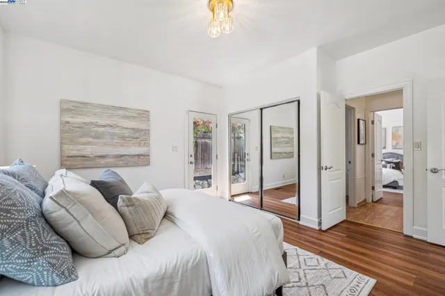 a bedroom with a bed and a chandelier
