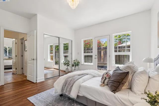 a bedroom with a bed and a large window