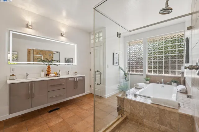 a large bathroom with a large tub and sink