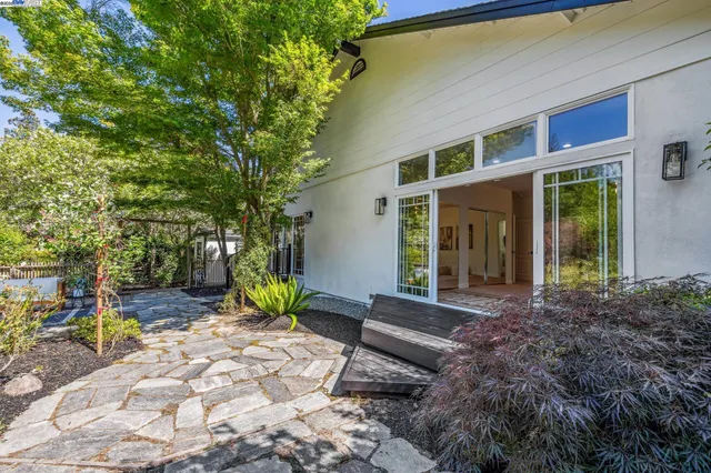 a view of house with backyard and outdoor seating