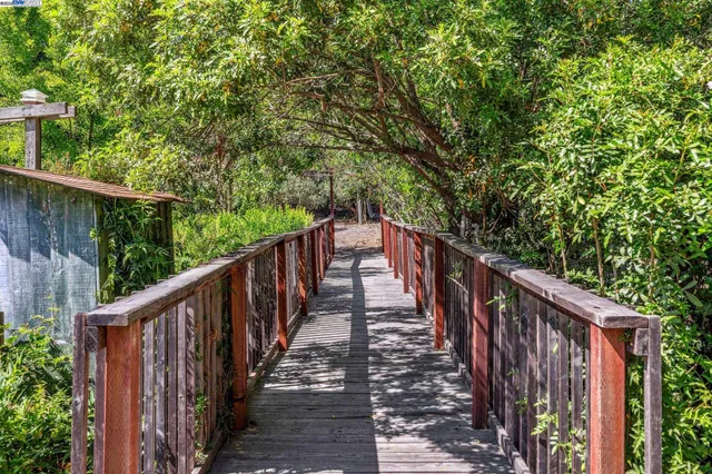 a view of a balcony with wooden floor and fence