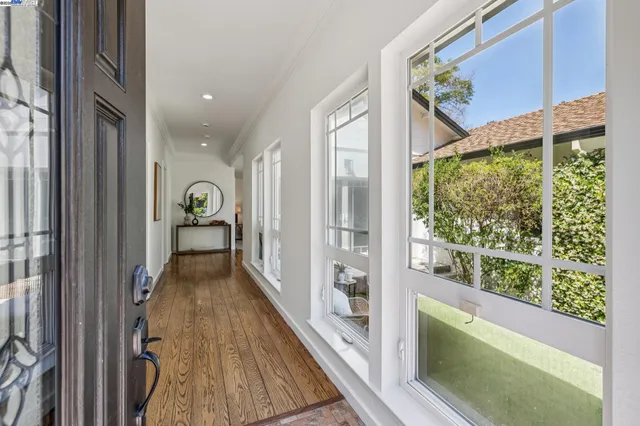 a view of hallway with furniture and a gate