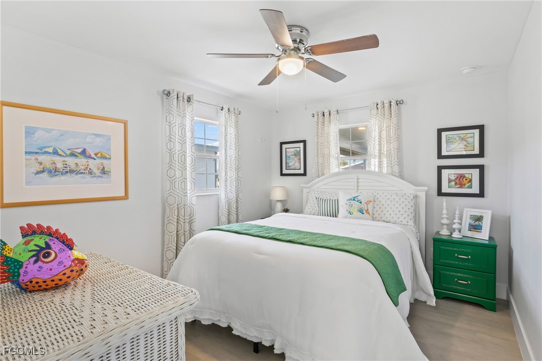 2556 Cay Cove Matlacha, FL 33993 - Photo 20 of 44 a bedroom with a bed and a chandelier