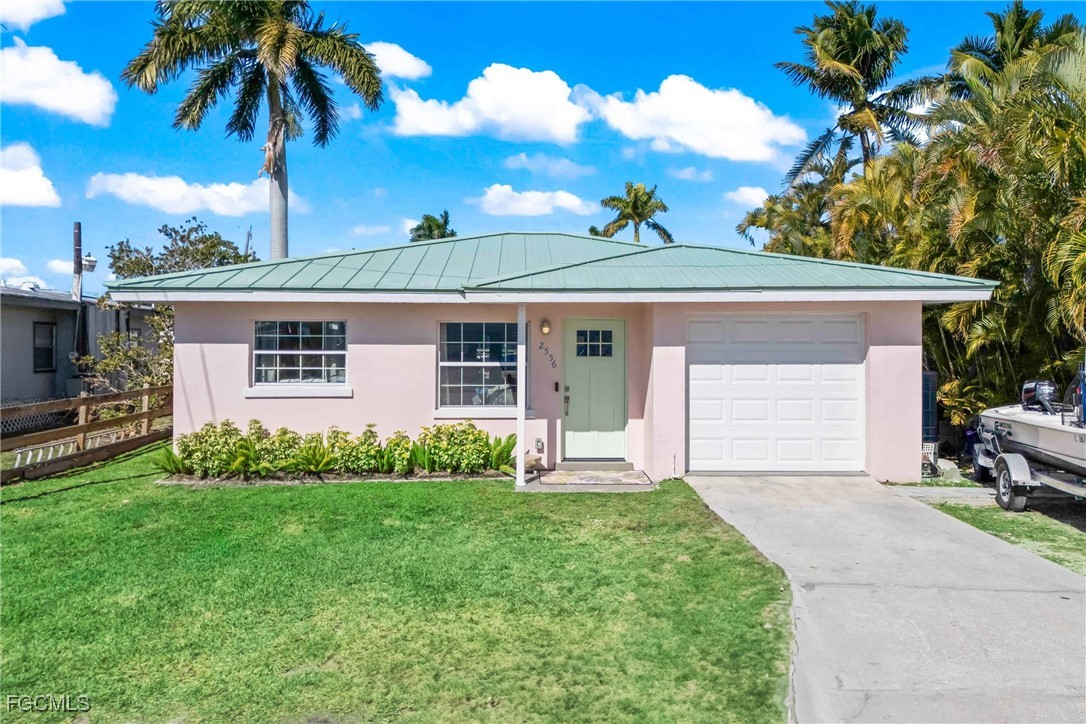 2556 Cay Cove Matlacha, FL 33993 - Photo 2 of 44 a front view of a house with a garden and yard