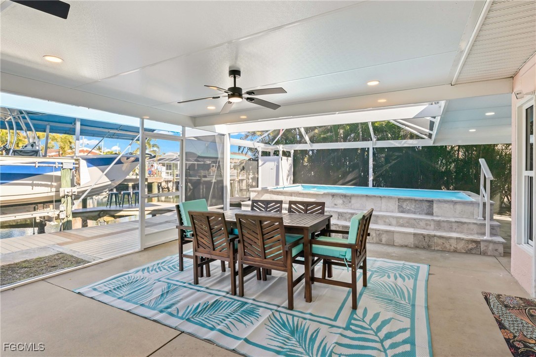 2556 Cay Cove Matlacha, FL 33993 - Photo 22 of 44 a dining room with furniture a rug and a floor to ceiling window