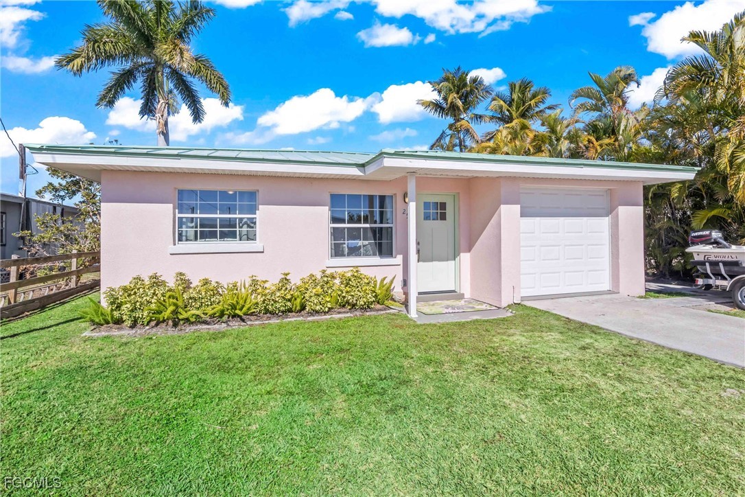 2556 Cay Cove Matlacha, FL 33993 - Photo 43 of 44 front view of a house with a big yard