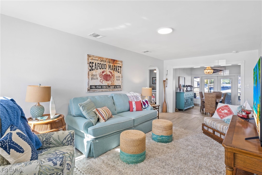 2556 Cay Cove Matlacha, FL 33993 - Photo 5 of 44 a living room with furniture and a flat screen tv