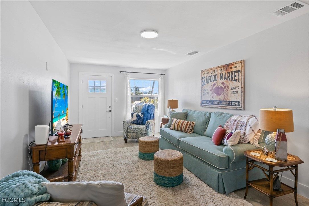 2556 Cay Cove Matlacha, FL 33993 - Photo 9 of 44 a living room with furniture and a potted plant