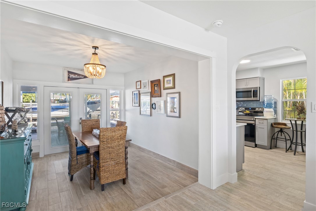 2556 Cay Cove Matlacha, FL 33993 - Photo 10 of 44 a view of a dining room with furniture window and wooden floor