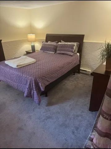 a bedroom with a bed and a couch