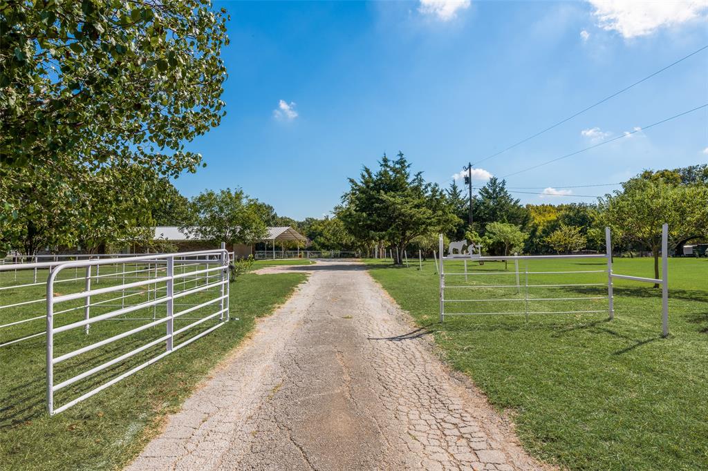 3092 North Trinity Street Decatur, TX 76234 - Photo 1 of 29 View of asphalt driveway with a gate, a gated entry, and a view of countryside