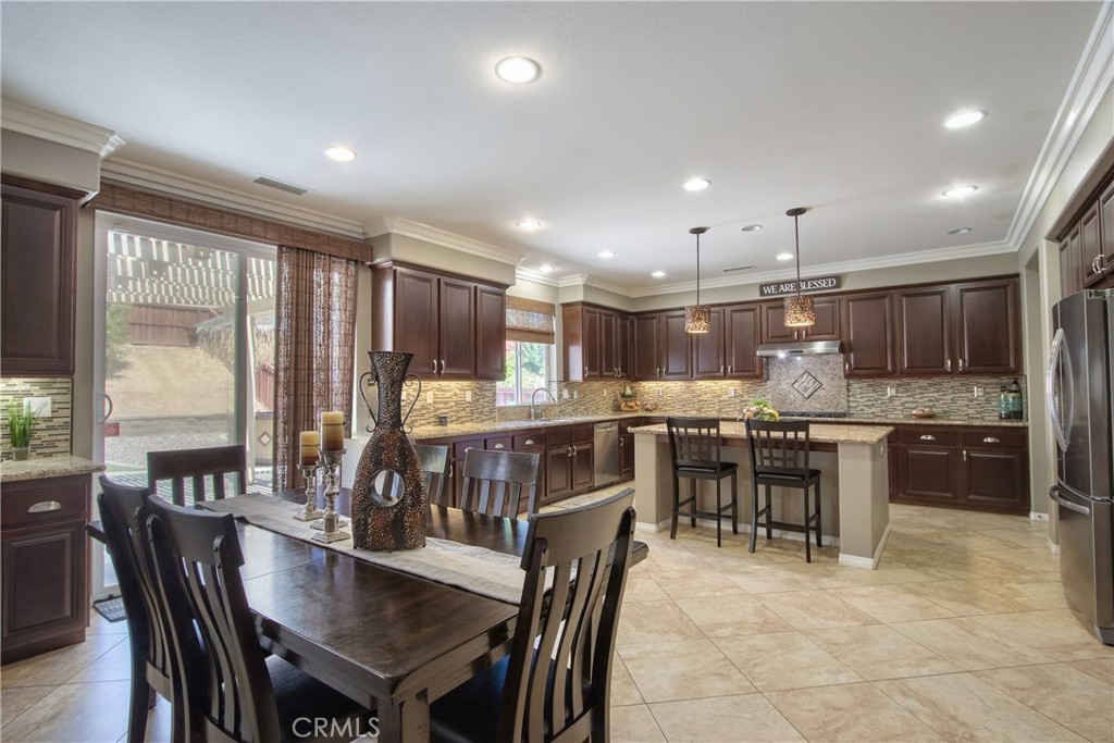 28483 Nautical Point Circle Menifee, CA 92585 - Photo 7 of 44 a kitchen with a table and chairs