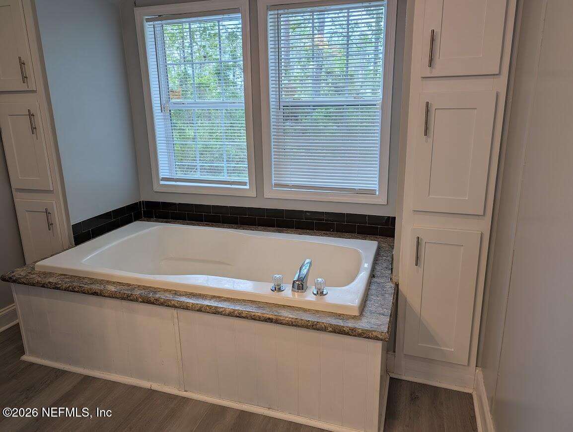 598 San Mateo Road San Mateo, FL 32187 - Photo 11 of 14 a bathroom with a granite countertop sink and a window