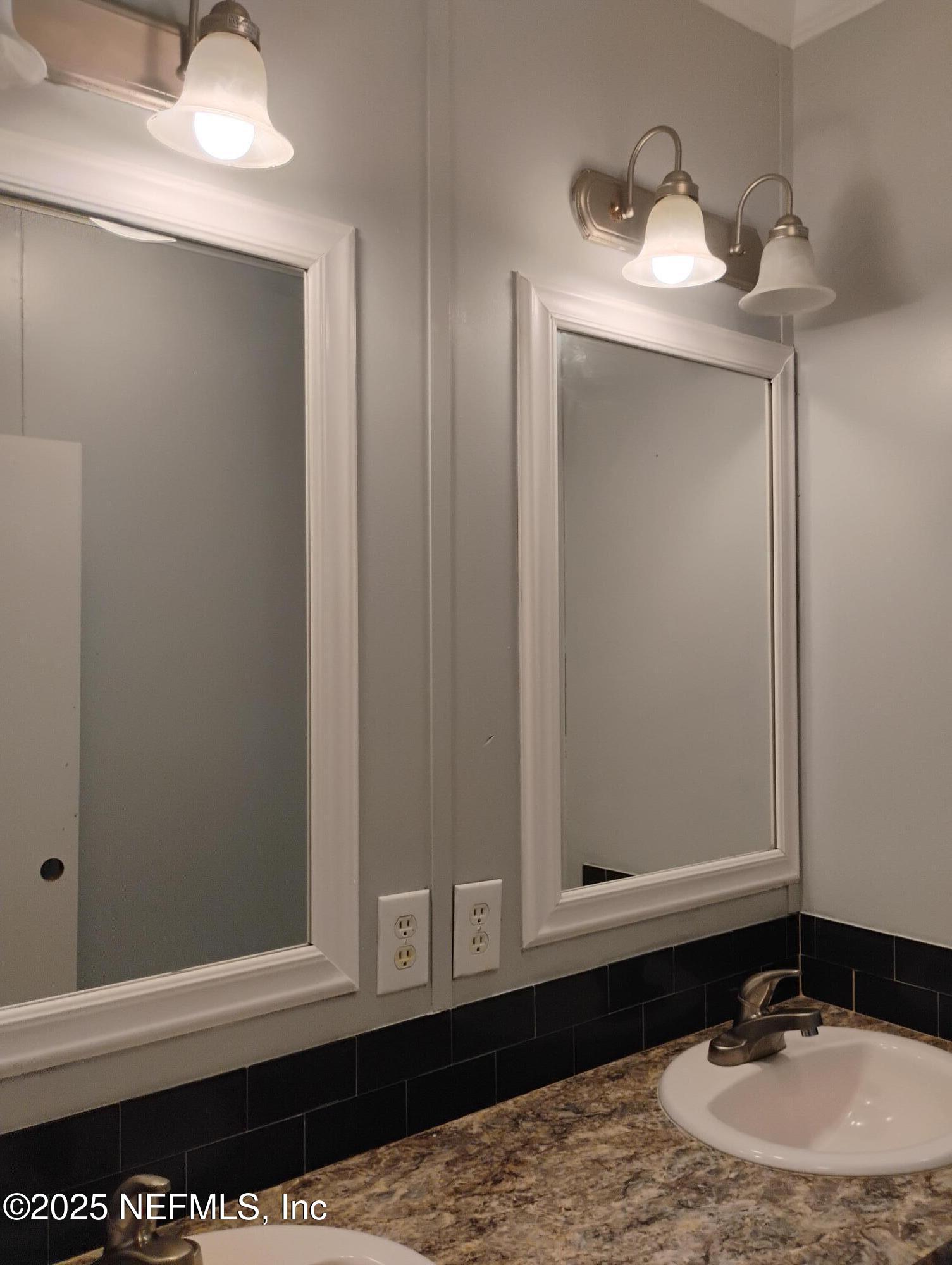 598 San Mateo Road San Mateo, FL 32187 - Photo 6 of 12 a bathroom with a sink and a mirror