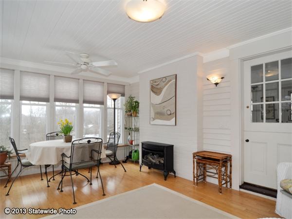 452 Highland Road Tiverton, RI 02878 - Photo 21 of 26 a living room with furniture a fireplace and a window