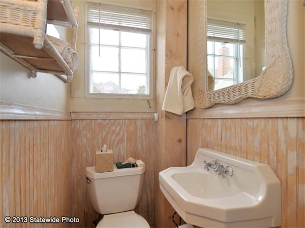 452 Highland Road Tiverton, RI 02878 - Photo 23 of 26 a bathroom with a sink a toilet and a window