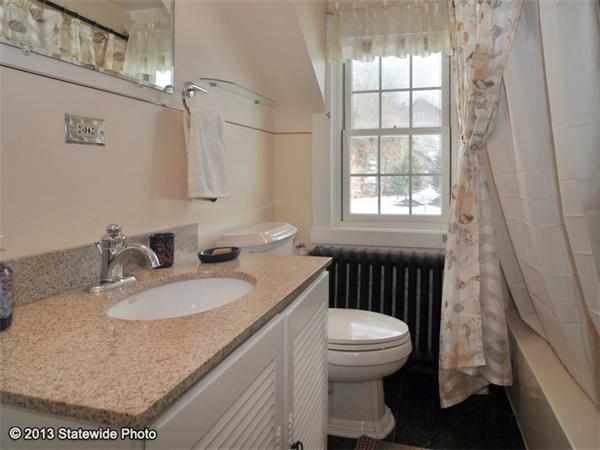 452 Highland Road Tiverton, RI 02878 - Photo 25 of 26 a bathroom with a granite countertop sink mirror vanity and toilet