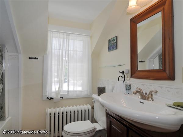 452 Highland Road Tiverton, RI 02878 - Photo 26 of 26 a bathroom with a sink and a mirror